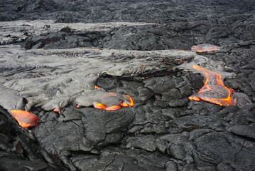 Hot magma flows  over old lava field