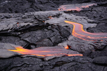 Hot magma flows  over old lava field