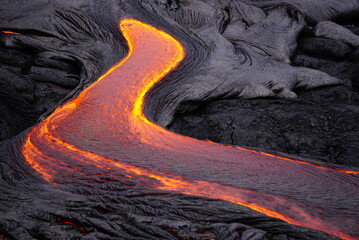 Detail of hot magma flowing over old lava field