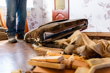 Getting rid of old things. Disassembling an old sofa in the attic.