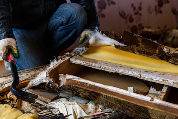 Getting rid of old things. Disassembling an old sofa in the attic.