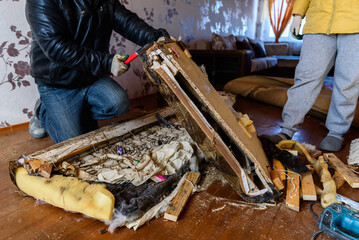 Getting rid of old things. Disassembling an old sofa in the attic.