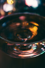 Abstract multicolour background. New Year lights. Blurred colourful light on champagne glass. Rainbow flash in dark. Futuristic shiny background. Illuminated effect. Bright glowing.