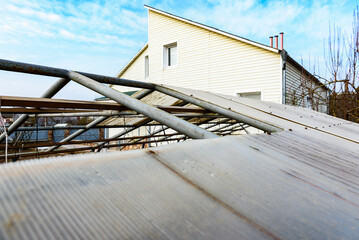 Greenhouse repair. Removal old polycarbonate using knife.