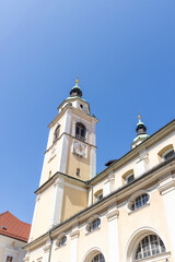 Fototapeta premium Saint Nicolas cathedral in Ljubljana in front of blue sky, capital city of Slovenia