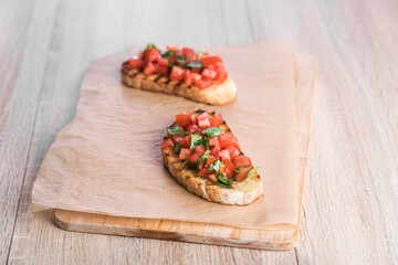 Bruschetta with tomatoes and basil prepared for breakfast
