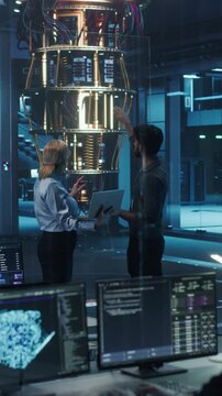 Vertical Screen: Engineers Collaborating on Quantum Computer Development, Analyzing Data on Advanced AI Software in a Laboratory. Diverse Team Focusing on Innovation and Technology Breakthroughs