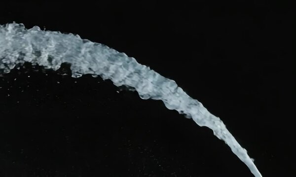 Water jet stream against dark background