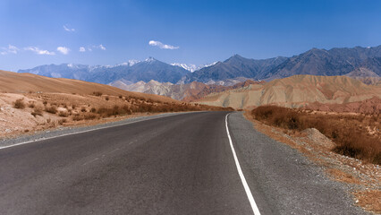 A road with mountains in the background