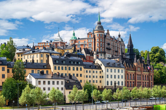 Stockholm, Sweden - August 5, 2024: Cityscape of the hillside of Mariaberget quarter with old buildings including the Mariahissen (right), overlooked by the Laurinska house on a sunny summer day.
