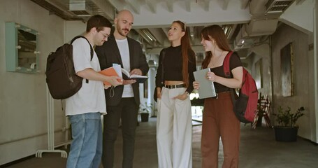 High School Students Consulting Their Professor About Assignments After Class: A Group of Students Discussing Their Homework with Their Teacher in a School Hallway