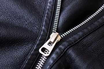 This is a Stylish Black Leather Jacket that features Fur Trim and intricate Zipper Details