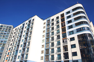 A very tall building stands prominently beneath a clear blue sky
