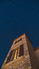 The night sky filled with stars viewed above a traditional stone Pigeonnier tower in the Dordogne...