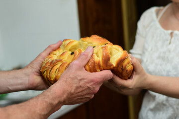 Man and woman sharing bread, part of orthodox slava ritual