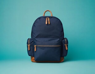 Stylish navy blue backpack with tan accents on a vibrant turquoise background.