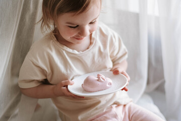 little girl and healthy easter sweets - jelly bunny