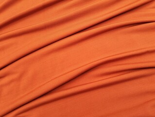 Fototapeta premium Orange abstract background. Orange silk satin texture background. Beautiful wavy soft folds on the surface of the fabric