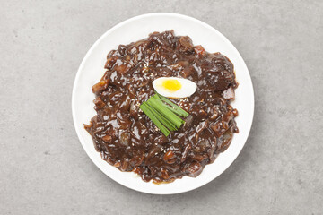 Jjajangmyeon is one of Chinese dishes. The noodles are mixed with Chinese soybean paste stir-fried with meat and vegetables.