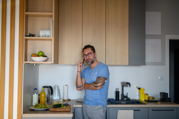 Diabetic man with CGM sensor making phone call.