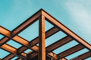 Construction is underway on a metal frame building with a beam-based structure at the site