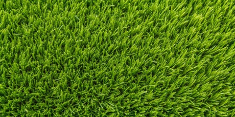 Vibrant green grass texture showcasing the beauty and detail of artificial turf in a well-maintained landscape setting wallpaper, background, texture detailed,   green grass, summer