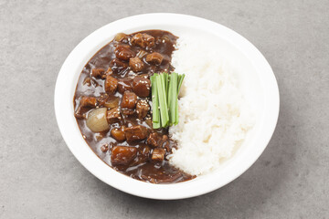 A food made by frying meat, potatoes, pumpkin, and onions in Chinese soybean paste and putting the sauce on top of rice.