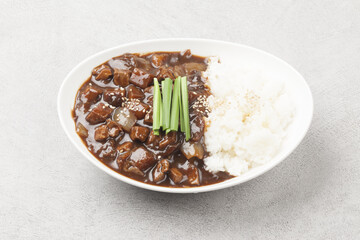 A food made by frying meat, potatoes, pumpkin, and onions in Chinese soybean paste and putting the sauce on top of rice.