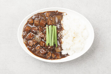 A food made by frying meat, potatoes, pumpkin, and onions in Chinese soybean paste and putting the sauce on top of rice.