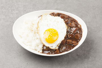 A food made by frying meat, potatoes, pumpkin, and onions in Chinese soybean paste and putting the sauce on top of rice.