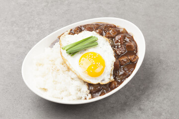 A food made by frying meat, potatoes, pumpkin, and onions in Chinese soybean paste and putting the sauce on top of rice.