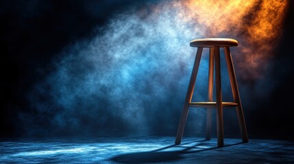 Empty wooden bar stool in dramatic stage lighting