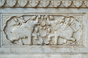 India. Rajasthan. Jaipur. Gatore Ki Chhatriyan. Magnificent marble memorial dedicated to Maharaja Sawai Mansingh II and his family. Bas relief representing Maharadjas on elephants