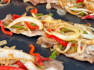 closeup of cooking street food , meat, vegetables, fried eggs , in the street market on summer day outdoors