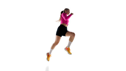Intense female runner mid-leap, demonstrating speed, control, and determination in professional training against white studio background. Concept of athletics, sport, endurance, healthy lifestyle. Ad