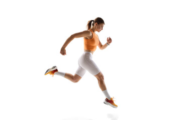 Fototapeta premium Active sports woman during her training, running, displaying discipline and strength against white studio background. Concept of athletics, sport, endurance, fitness, healthy lifestyle. Ad