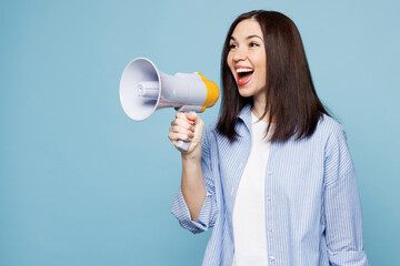 Young Caucasian woman wears shirt casual clothes hold in hand megaphone scream announces discounts sale Hurry up isolated on plain pastel light blue cyan background studio portrait. Lifestyle concept.
