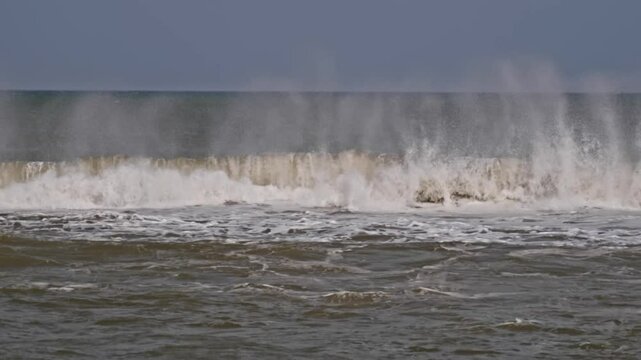 waves are rolling in ocean with sky at marina beach, triplicane, chennai, tamil nadu, india. day time, stable shot, 4k.