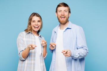 Young couple two friends family man woman wears shirt casual clothes together point index finger...