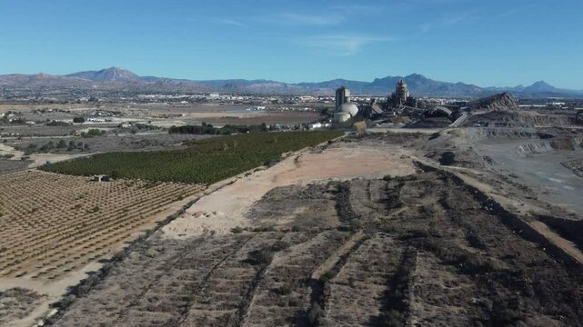 Aerial approach to a cement factory. Looks like an apocalyptic building.
