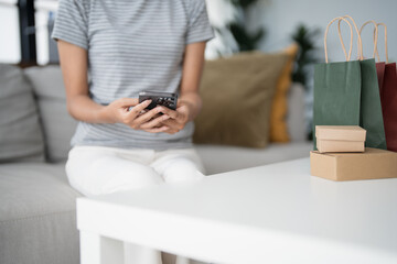 Asian woman texting checking social media holding smartphone at home Conversation