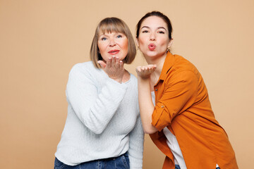 Elder happy parent mom 50s years old with young adult daughter two women together wear casual...