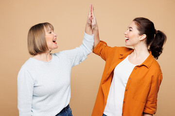 Elder parent mom 50s years old, young adult daughter two women together wearing casual clothes meet...