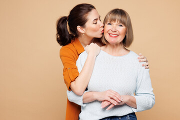Elder European happy parent mom 50s years old with young adult daughter two women together wearing...