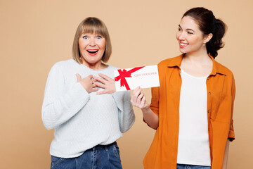 Elder surprised parent mom 50s years old with young adult daughter two women together wear casual...