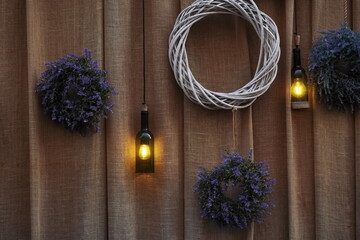 the wreaths, handmade lamps from dark glass bottles on curtain b