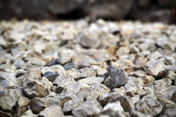 Close-up light beige and white small stones, gravel rugged backg