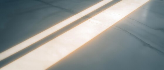 Obraz premium Close-up of a white surface with a diagonal line of light shining through it. the light is casting a warm glow on the surface, creating a contrast between the light and the dark background.