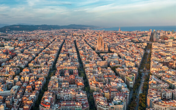 Aerial view of Barcelona Eixample residential district and famous Basilica Sagrada Familia at sunset. Catalonia, Spain.