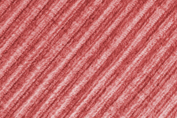 Ridge macro texture of velour corduroy red cloth. Large ribbed, diagonal coarse weaving velveteen,...